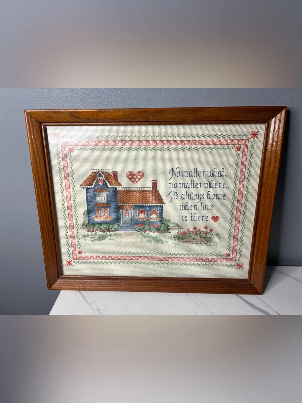 Framed Cross Stitch Home Sampler with Blue House and Quote